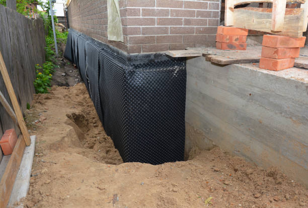 SJ Waterproofing Pros technician performing targeted Wet Basement Repair assessment in Londonderry, OH